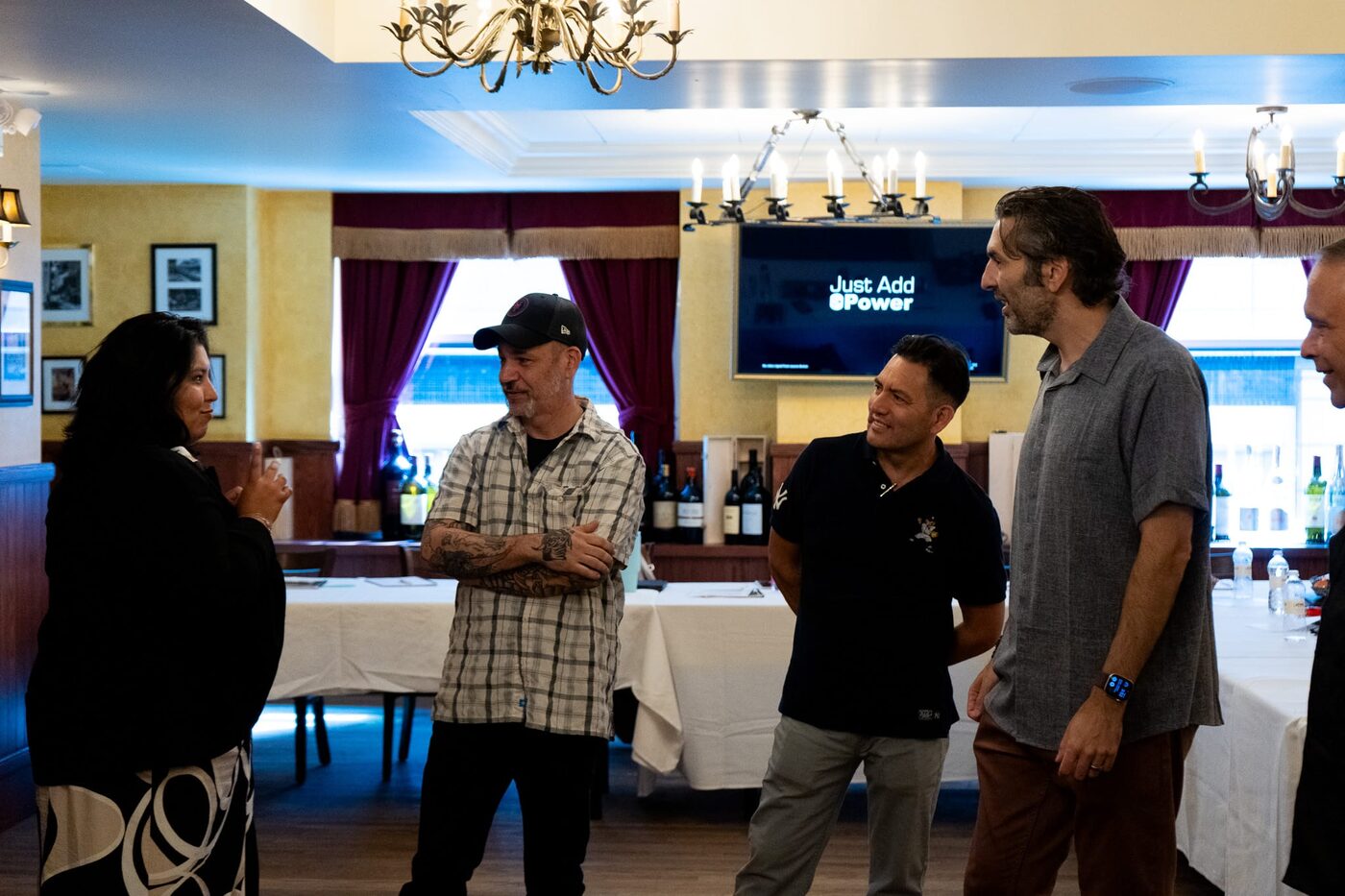 A team laughing together mid-exercise during an improv workshop